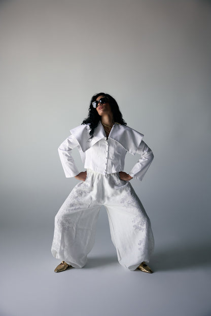 Model wearing White Origami-Collar Cropped Jacket & Jacquard Wide-Leg Trousers — view 2, Doha Zaitoon